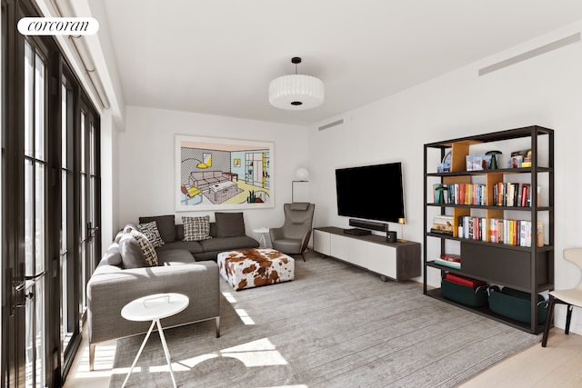 living area with healthy amount of natural light and wood finished floors