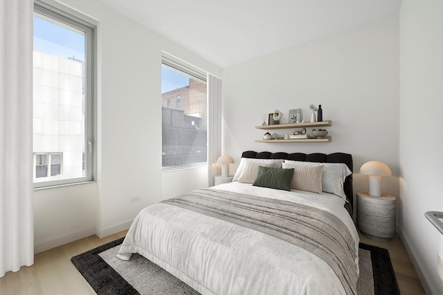 611 W 56th St Unit 3D, New York City, NY 10019 - bedroom featuring light wood-type flooring and baseboards