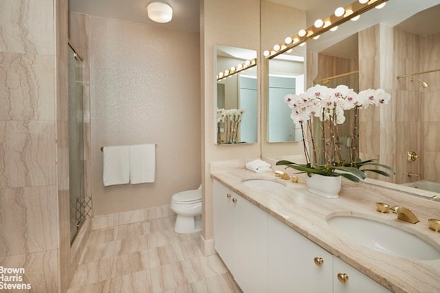 full bath featuring a shower, toilet, and double vanity