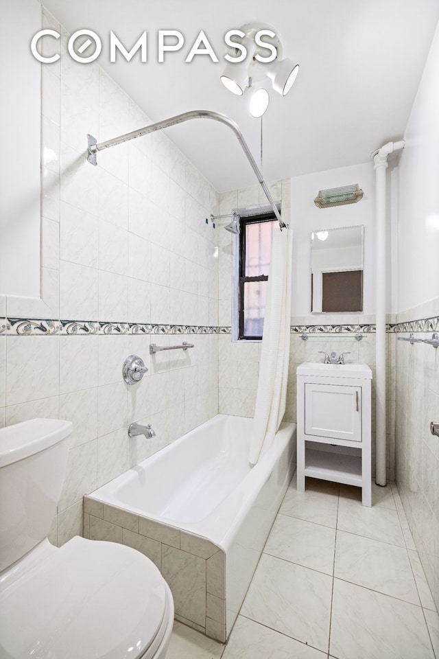 226-230 E 12th St Unit 1H, New York City, NY 10003 - bathroom featuring tile walls, toilet, shower / tub combo, tile patterned floors, and vanity