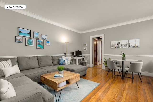 living room featuring crown molding, light wood-style floors, and baseboards