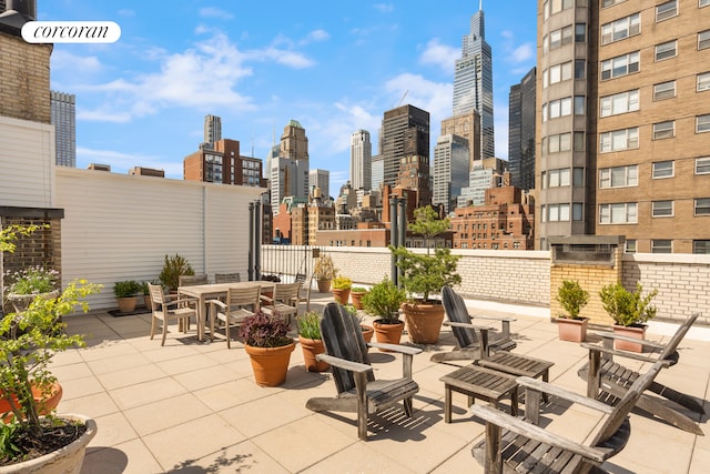 view of patio / terrace featuring a view of skyline and outdoor dining space