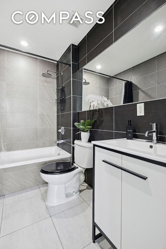 280 Nassau Ave Unit 1A, New York City, NY 11222 - bathroom featuring toilet, tile walls, vanity, tiled shower / bath, and tile patterned floors