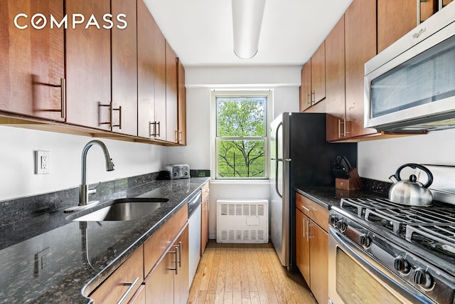 1065 Vermont St Unit 4L, New York City, NY 11207 - kitchen featuring stainless steel appliances, light wood-style flooring, and brown cabinetry