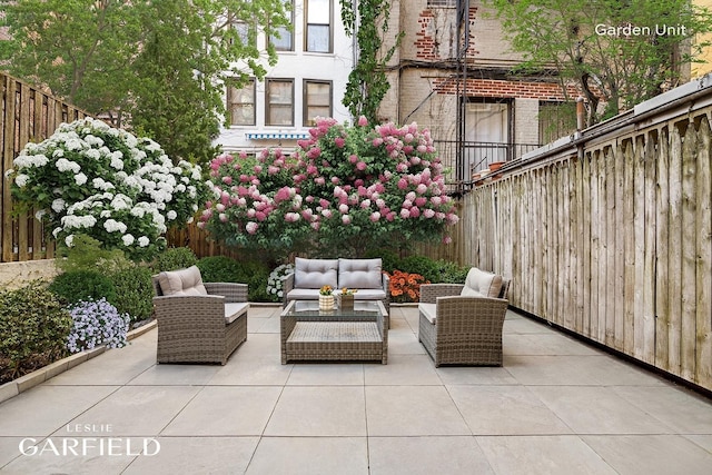 view of patio featuring outdoor lounge area and fence