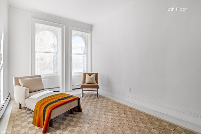 sitting room with light carpet and a baseboard heating unit