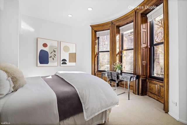 bedroom with light colored carpet, recessed lighting, and baseboards