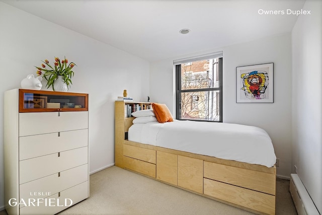 bedroom featuring light carpet and a baseboard radiator