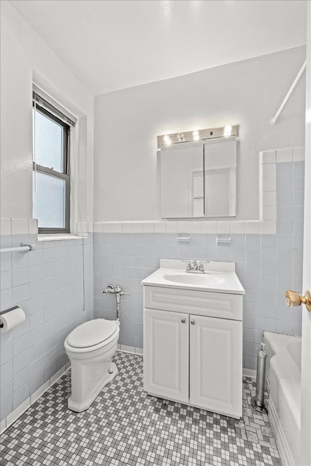 3601 Johnson Ave Unit 5K, New York City, NY 10463 - full bathroom featuring tile walls, a tub, vanity, wainscoting, and tile patterned flooring