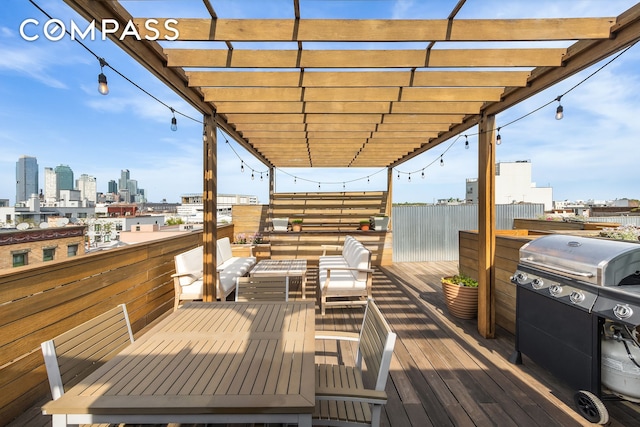 deck featuring a pergola, a view of skyline, and area for grilling