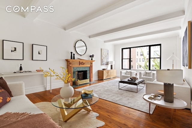 33 E 70th St Unit 9D, New York City, NY 10021 - living area featuring beam ceiling, wood finished floors, a high end fireplace, and baseboards