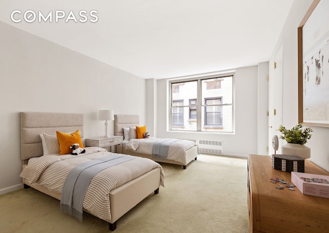 bedroom featuring radiator and carpet flooring