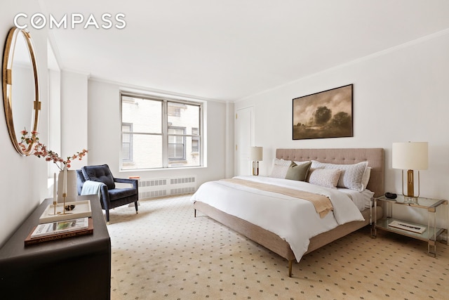 bedroom with radiator heating unit, crown molding, and light carpet