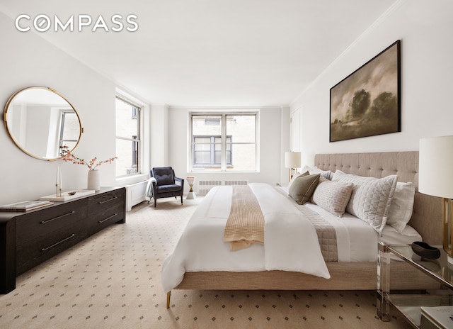 bedroom with radiator heating unit and light colored carpet