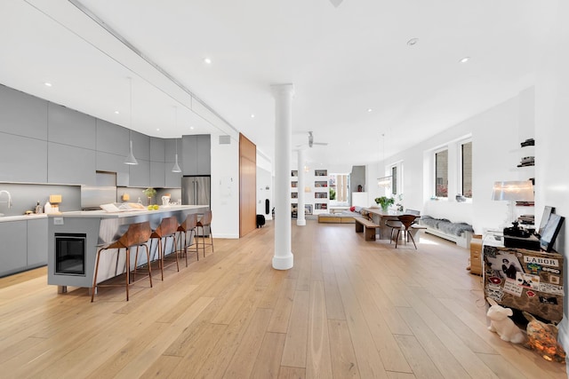 131 5th Ave Unit 601, New York City, NY 10011 - living room with light wood finished floors, decorative columns, and recessed lighting