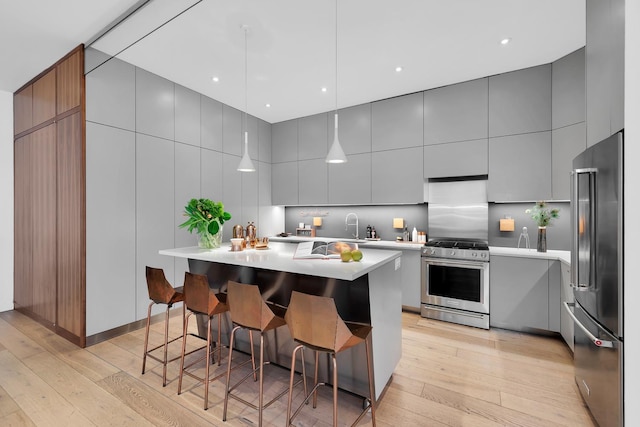 131 5th Ave Unit 601, New York City, NY 10011 - kitchen featuring stainless steel appliances, gray cabinets, and light wood finished floors