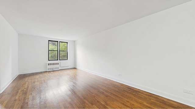 599 E 7th St Unit 2B, New York City, NY 11218 - empty room with radiator heating unit, wood finished floors, and baseboards