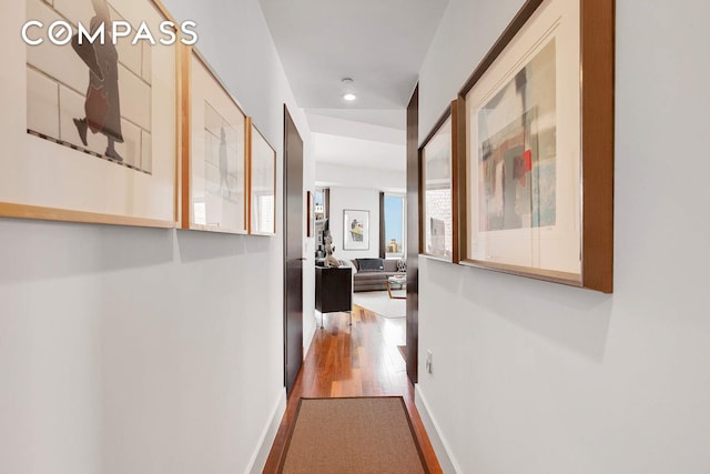 hallway with wood finished floors, recessed lighting, and baseboards