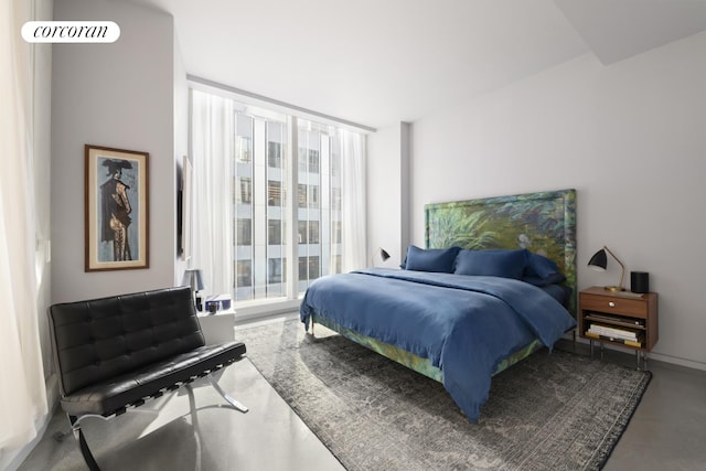 100 E 53rd St Unit 5-A, New York City, NY 10022 - bedroom featuring floor to ceiling windows, access to exterior, and finished concrete floors