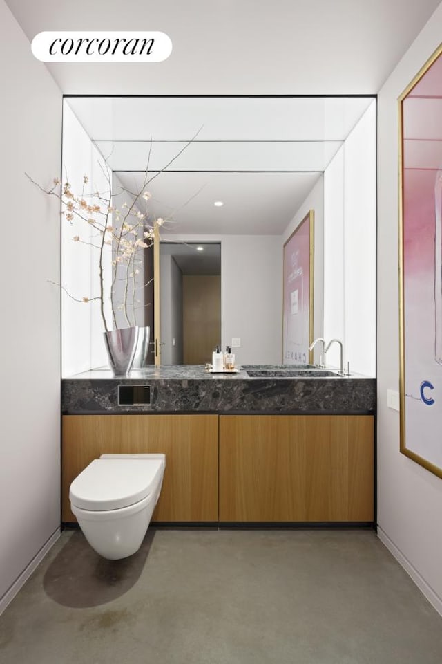 100 E 53rd St Unit 5-A, New York City, NY 10022 - bathroom with concrete floors, vanity, toilet, and baseboards