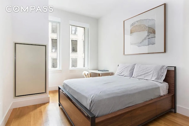 101 Leonard St Unit 4A, New York City, NY 10013 - bedroom with light wood-type flooring and baseboards
