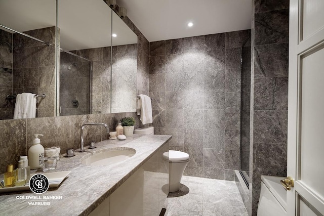 bathroom featuring tile walls, tiled shower, toilet, vanity, and recessed lighting