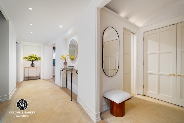 hallway with recessed lighting, light tile patterned flooring, and baseboards