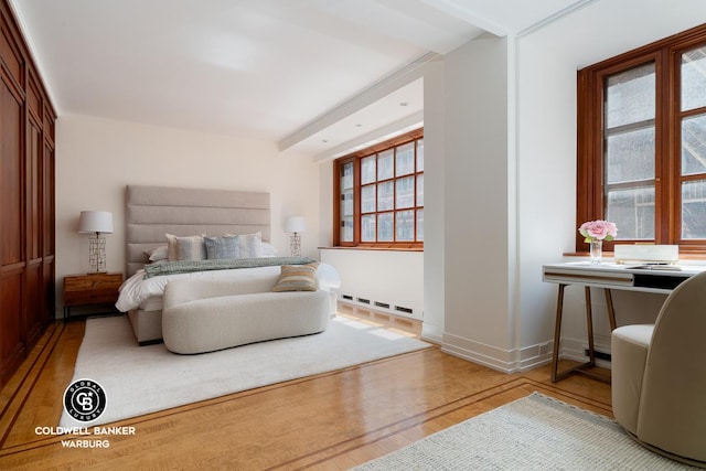 bedroom featuring wood finished floors and baseboards