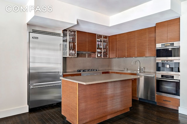 889 Broadway Pha, Pha, New York City, NY 10003 - kitchen featuring stainless steel appliances, a sink, dark wood-style flooring, decorative backsplash, and glass insert cabinets
