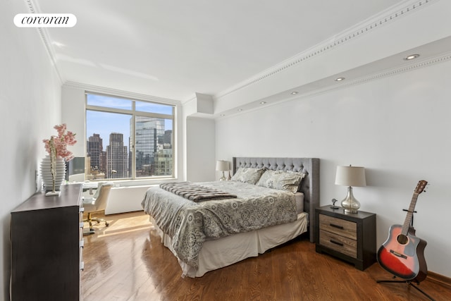 bedroom with a skyline view, wood finished floors, and crown molding