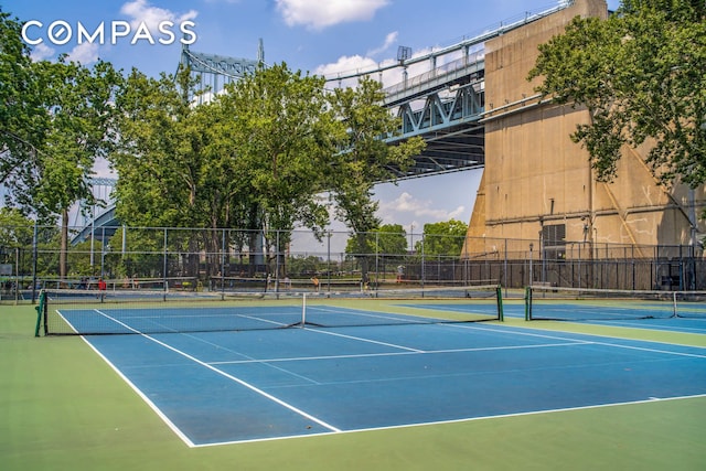 view of tennis court featuring fence