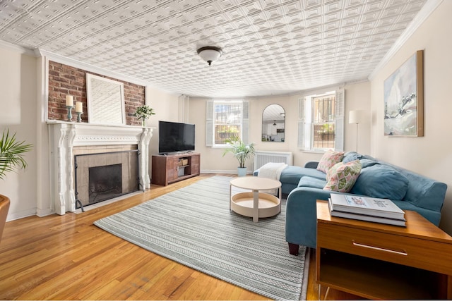 275 Degraw St Unit A, New York City, NY 11231 - living room with an ornate ceiling, ornamental molding, wood finished floors, a fireplace, and radiator