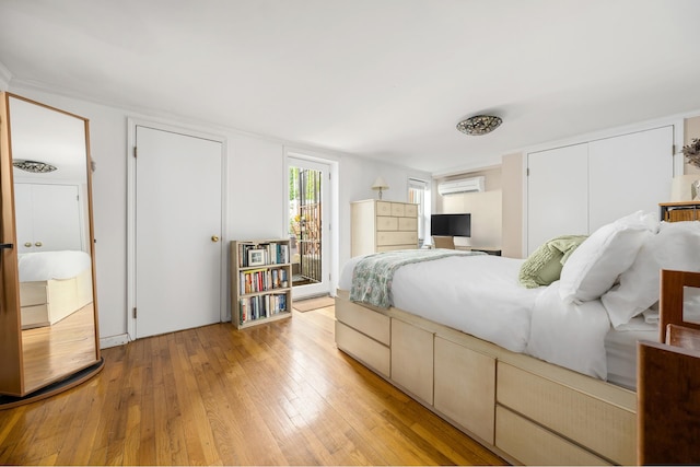 275 Degraw St Unit A, New York City, NY 11231 - bedroom featuring light wood-type flooring, an AC wall unit, and access to exterior