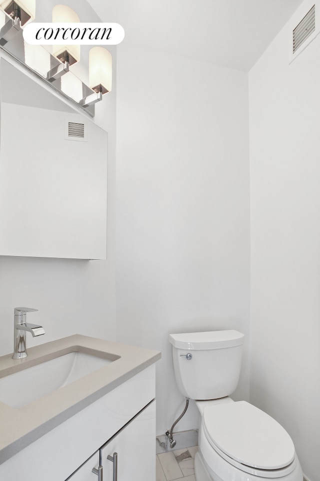 304 E 65th St Unit 26B, New York City, NY 10065 - half bath featuring vanity, toilet, and baseboards