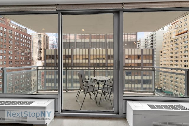 view of patio / terrace featuring a view of city and a balcony