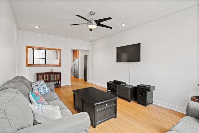 living area with ceiling fan, light wood finished floors, baseboards, and recessed lighting