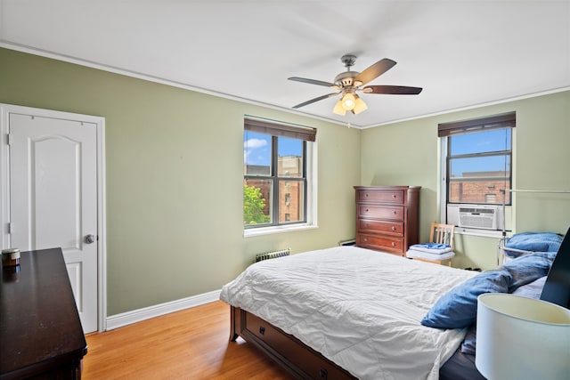 bedroom with light wood-type flooring, baseboards, multiple windows, cooling unit, and crown molding