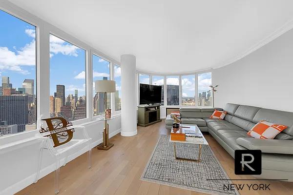 330 E 38th St Unit 48-E, New York City, NY 10016 - living room with wood finished floors and a view of city