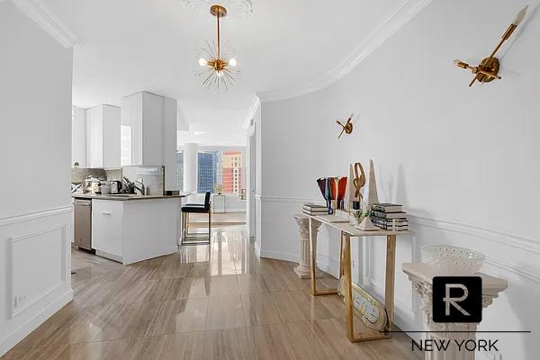 330 E 38th St Unit 48-E, New York City, NY 10016 - kitchen featuring crown molding, stainless steel dishwasher, white cabinets, decorative backsplash, and a chandelier