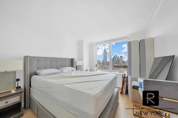 330 E 38th St Unit 48-E, New York City, NY 10016 - bedroom featuring light wood-style floors and a view of skyline