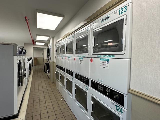 1641 3rd Ave Unit 28B, New York City, NY 10128 - community laundry with stacked washer and clothes dryer, washer and clothes dryer, and light tile patterned floors