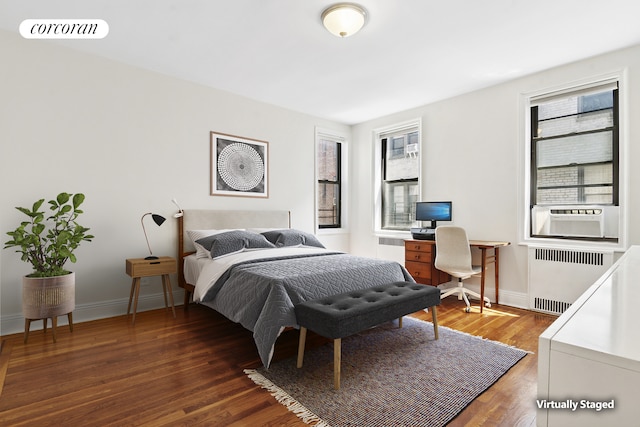 45 Martense St Unit 5L, New York City, NY 11226 - bedroom featuring radiator heating unit, multiple windows, wood finished floors, and baseboards