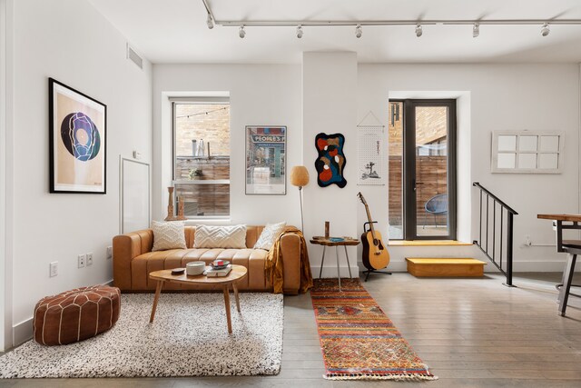 416 W 52nd St Unit 225, New York City, NY 10019 - living room with rail lighting, hardwood / wood-style floors, and baseboards