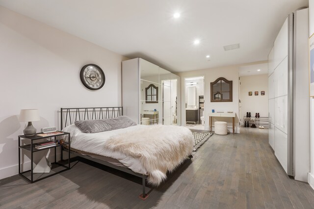416 W 52nd St Unit 225, New York City, NY 10019 - bedroom with hardwood / wood-style floors, connected bathroom, and recessed lighting