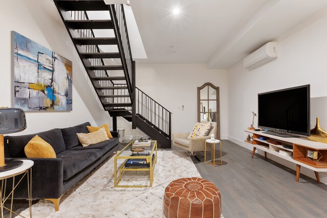 416 W 52nd St Unit 225, New York City, NY 10019 - living area with a wall unit AC, stairway, wood finished floors, and baseboards