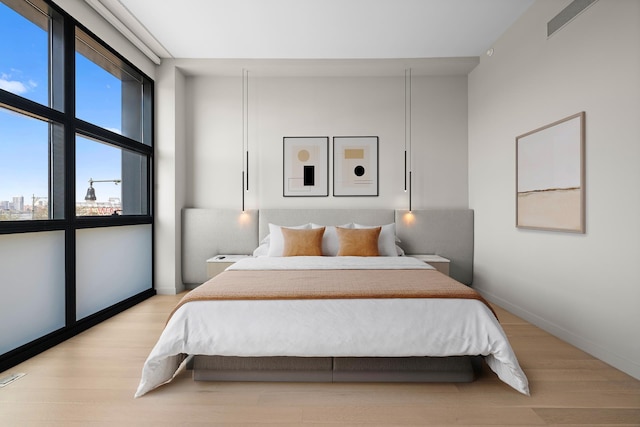 bedroom with wood finished floors and baseboards