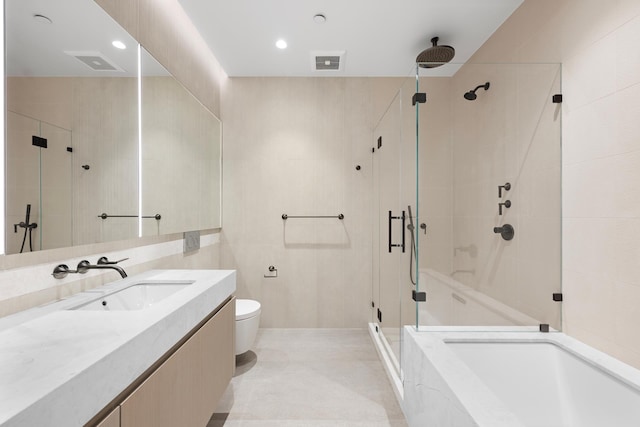 full bath featuring a stall shower, toilet, vanity, recessed lighting, and tile walls
