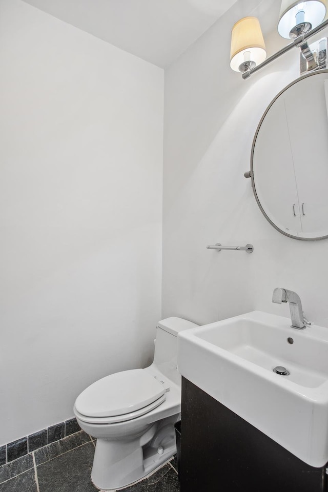 bathroom with toilet and vanity
