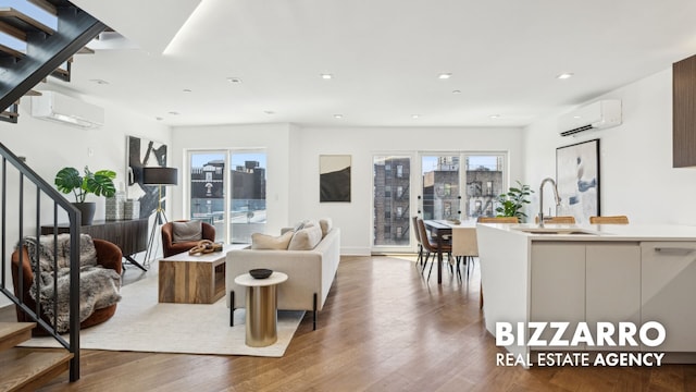 553 W 182nd St Unit 3R, New York City, NY 10033 - living room featuring a wall unit AC, stairs, wood finished floors, a view of city, and recessed lighting