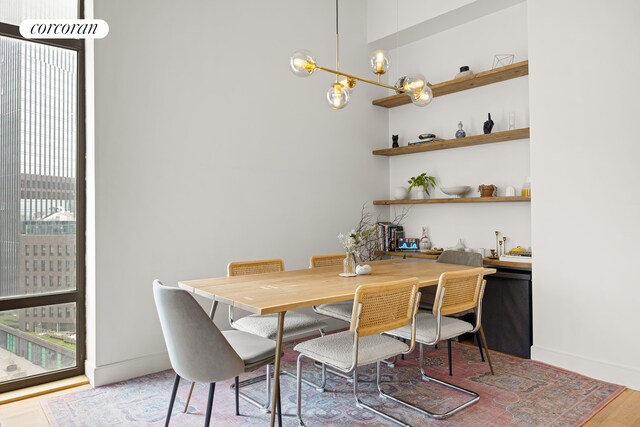 96 Rockwell Pl Unit 11C, New York City, NY 11217 - dining area featuring wood finished floors, healthy amount of natural light, and baseboards
